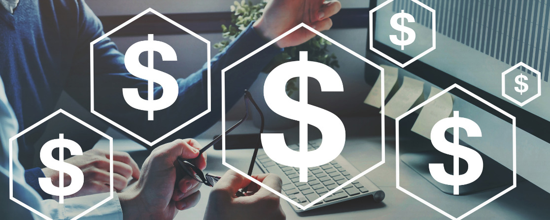 Someone looking at a computer screen displaying investments, with dollar signs superimposed over top