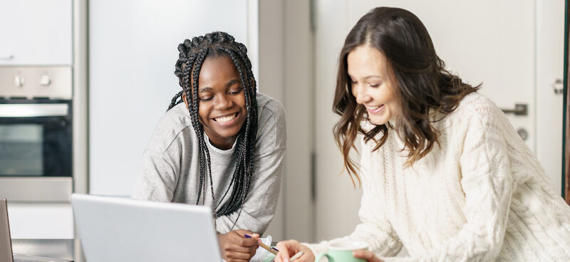Two students looking up the best scholarships for high school juniors.