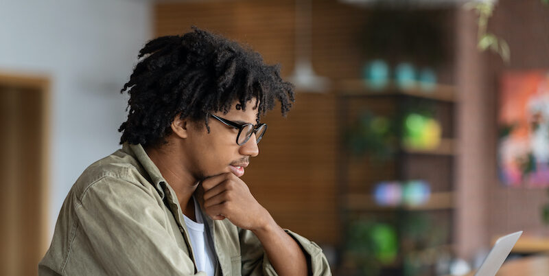 Young man researching buy now, pay later statistics