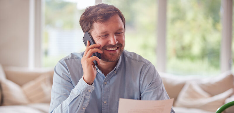 Man reviewing his personal loan paperwork from OneMain Financial.