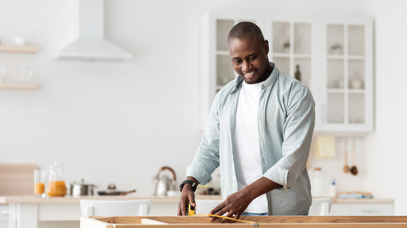 Gentleman working on home improvement project after reading Unison review to access home equity.