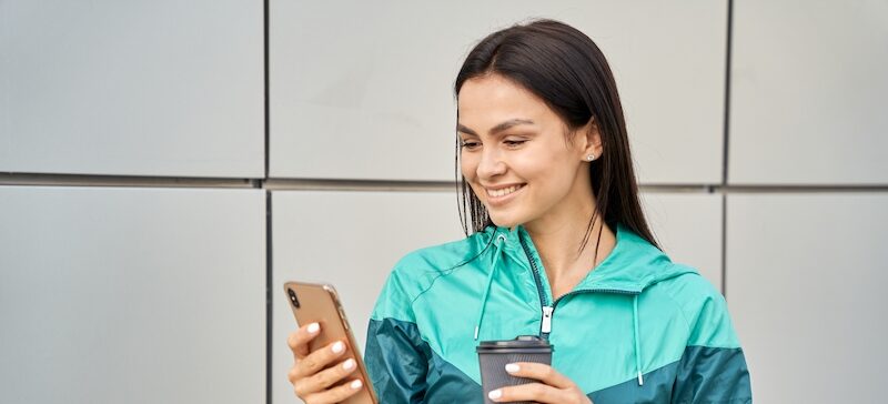 Young woman completing surveys for gift cards on her mobile device.