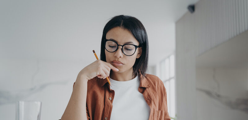 Woman researching 7% interest savings account options.