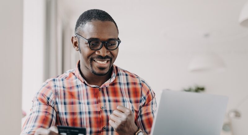Young man researching the best banks in America online.