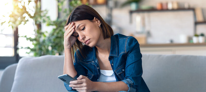 Young woman wondering, "Will Cash App refund money if scammed?"