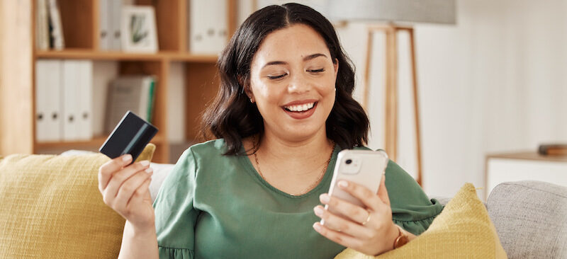 A young lady reading an Upgrade Bank review on her mobile device.