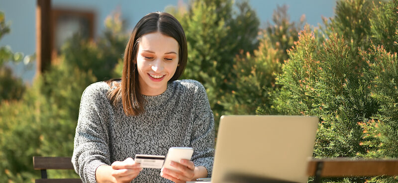Young woman on her phone learning how to add money to Cash App card.