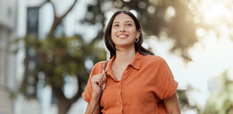 Young woman excited about starting college after find the best student loans for bad credit.