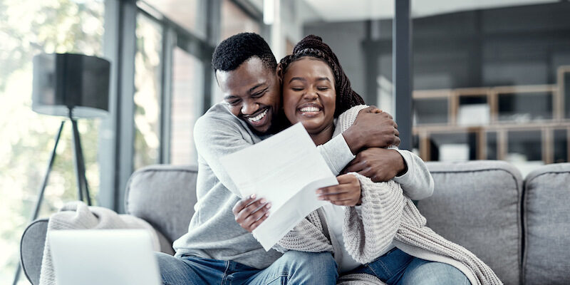 Young couple looking happy after they read this Debt Busters review.