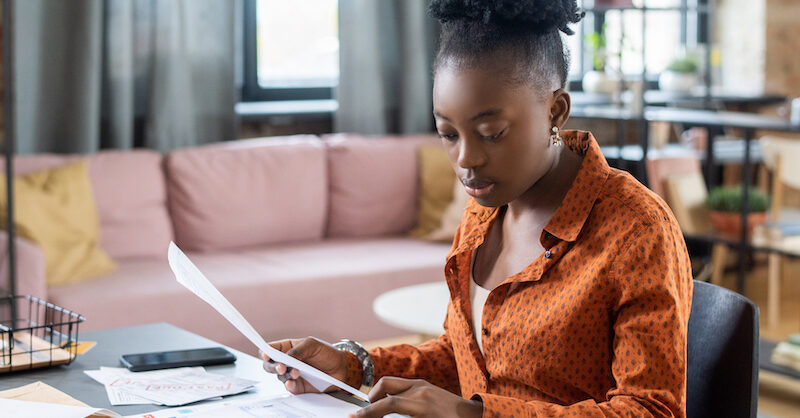 Young woman researching which savings account will earn you the most money.