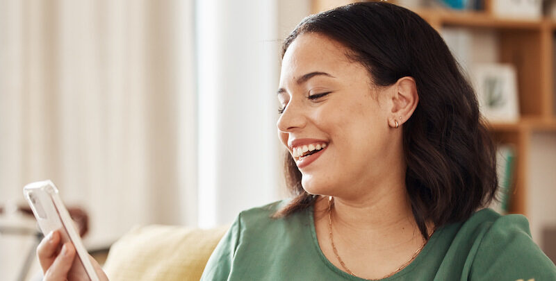 Young woman reading a Public.com review online.