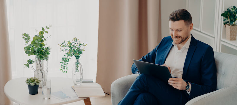 A businessman researching Fundrise vs Yieldstreet reviews online.