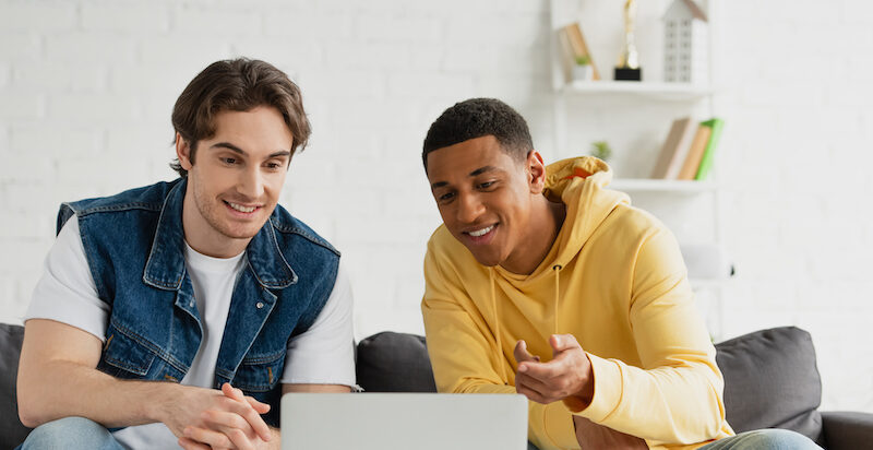 Two young men looking up the answer to, "Is Idle Empire legit?"
