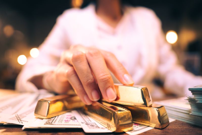 Woman holding gold bars