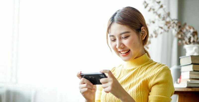 Woman smiling at phone.